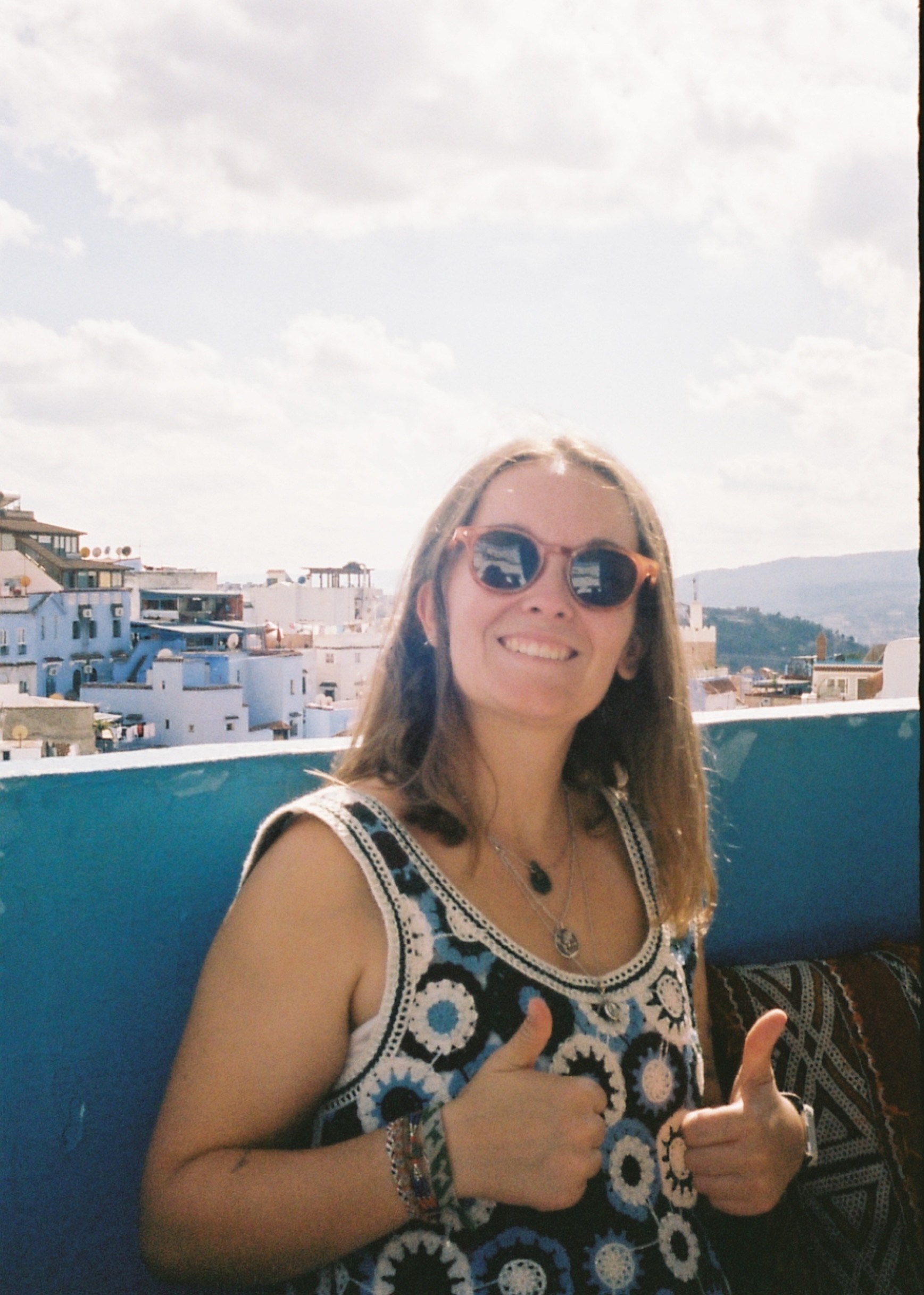 Portrait of the blog owner with face partially distorted through two clear glasses of water on a white table